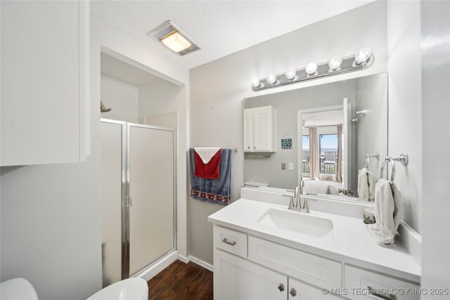 42 Diamond Head Dr Unit 42, Sand Springs, OK 74063 - full bathroom with toilet, a shower stall, vanity, and wood finished floors