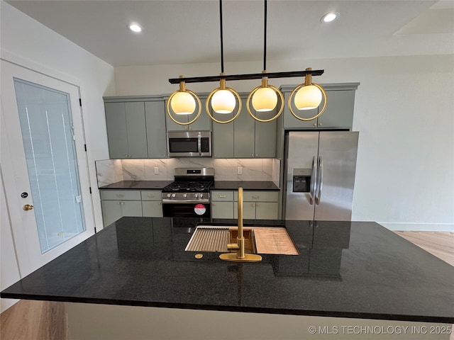 3204 N Hartford Ave, Tulsa, OK 74106 - kitchen with a kitchen island with sink, tasteful backsplash, recessed lighting, and stainless steel appliances