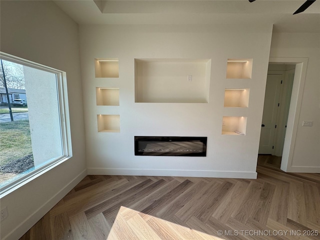 3204 N Hartford Ave, Tulsa, OK 74106 - unfurnished living room featuring baseboards, built in features, and a glass covered fireplace
