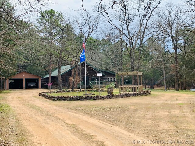 413822 S Sherman, Moyers, OK 74557 - view of front of house with driveway, an outbuilding, a garage, and a front lawn