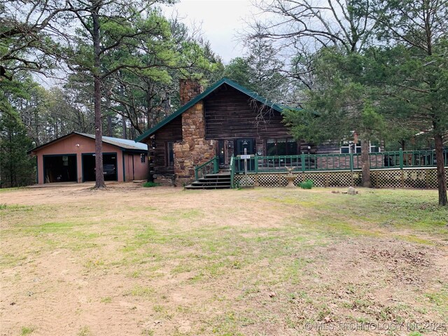 413822 S Sherman, Moyers, OK 74557 - rear view of house featuring an outdoor structure, a chimney, a wooden deck, a garage, and a lawn