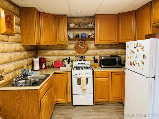 413822 S Sherman, Moyers, OK 74557 - kitchen featuring light countertops, a sink, open shelves, light wood-type flooring, and white appliances