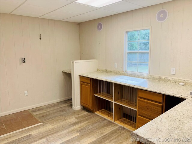 413822 S Sherman, Moyers, OK 74557 - kitchen featuring light wood-style flooring, baseboards, a drop ceiling, open shelves, and brown cabinetry