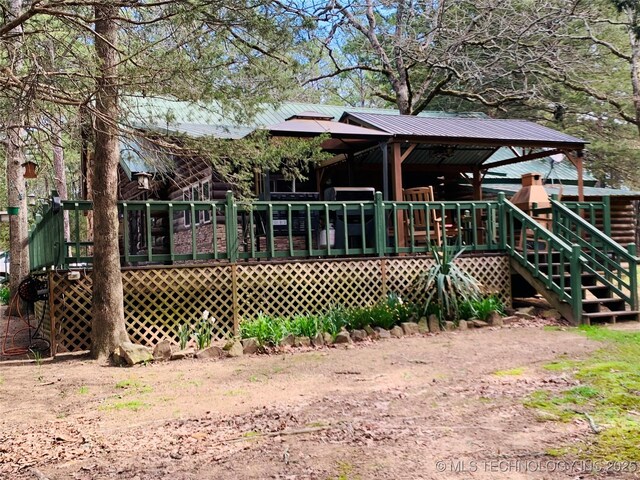 413822 S Sherman, Moyers, OK 74557 - rear view of house with metal roof and a wooden deck