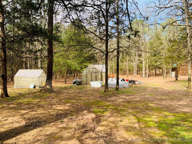 413822 S Sherman, Moyers, OK 74557 - view of yard with an outdoor structure, an exterior structure, and a view of trees