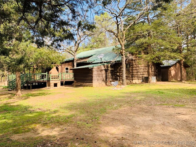 413822 S Sherman, Moyers, OK 74557 - view of yard featuring an outbuilding, a wooden deck, and a storage shed