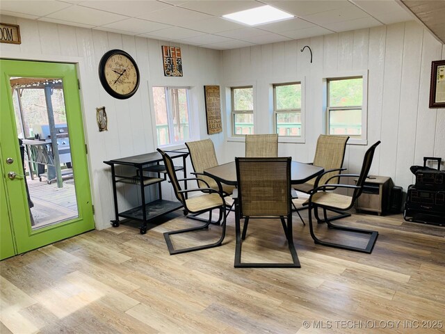413822 S Sherman, Moyers, OK 74557 - dining space featuring light wood-type flooring, a paneled ceiling, and a healthy amount of sunlight