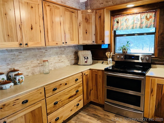 413822 S Sherman, Moyers, OK 74557 - kitchen featuring decorative backsplash, light countertops, wood finished floors, and range with two ovens