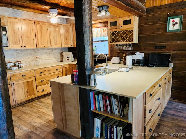 413822 S Sherman, Moyers, OK 74557 - kitchen featuring beamed ceiling, wood finished floors, wooden walls, and light brown cabinetry