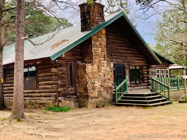 413822 S Sherman, Moyers, OK 74557 - view of side of property with metal roof, a wooden deck, log siding, and a chimney