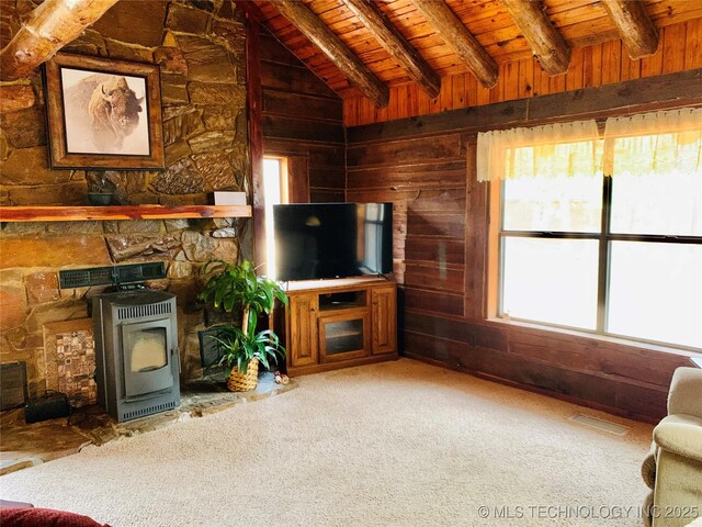 413822 S Sherman, Moyers, OK 74557 - unfurnished living room featuring lofted ceiling with beams, wood walls, heating unit, a wood stove, and wood ceiling