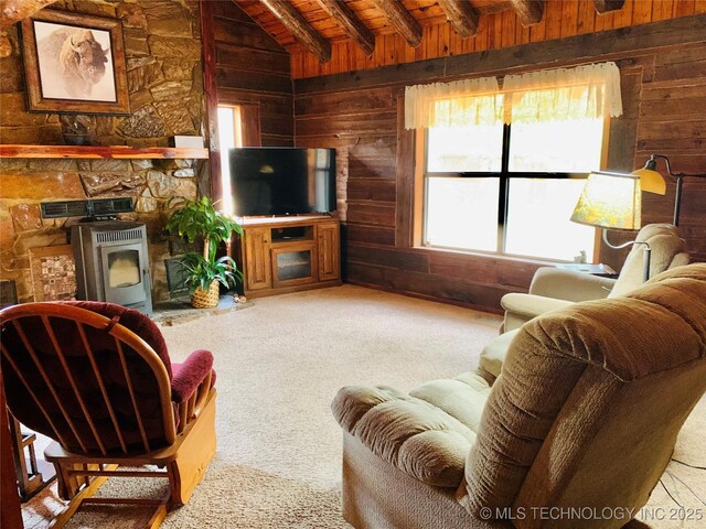 413822 S Sherman, Moyers, OK 74557 - living room with carpet floors, wood ceiling, vaulted ceiling with beams, wood walls, and a wood stove