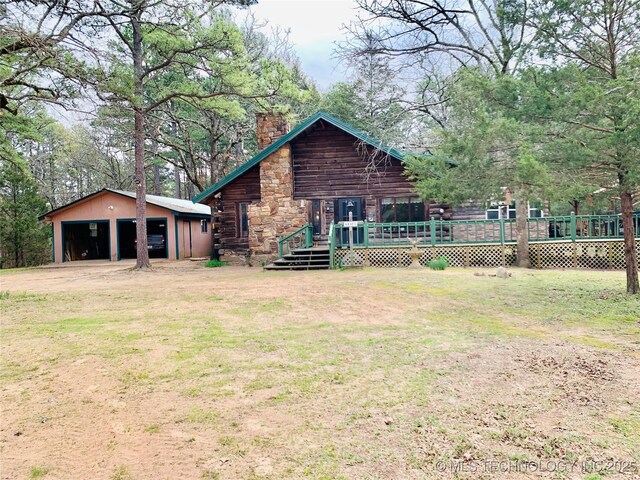 413822 S Sherman, Moyers, OK 74557 - rear view of property with a chimney, a garage, log siding, a lawn, and an outbuilding
