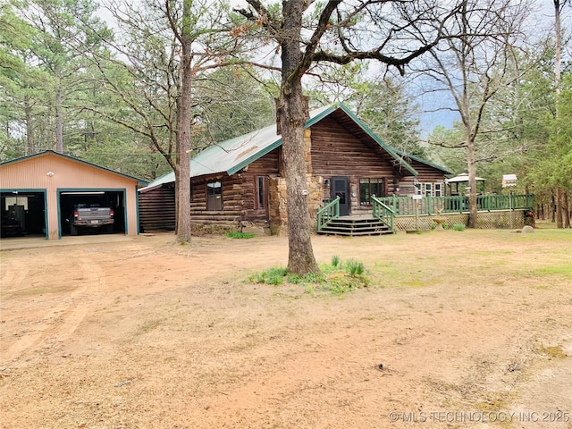 413822 S Sherman, Moyers, OK 74557 - exterior space with log exterior, a garage, a front yard, a deck, and an outbuilding