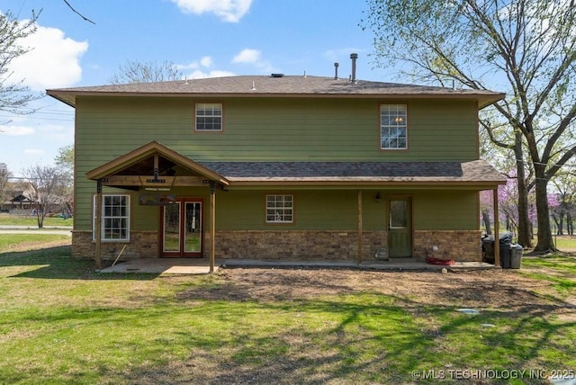 9012 S 49th W Ave, Tulsa, OK 74131 - rear view of house with a patio, stone siding, and a lawn