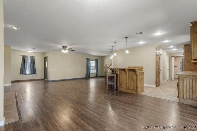 9012 S 49th W Ave, Tulsa, OK 74131 - unfurnished living room with visible vents, baseboards, a ceiling fan, and wood finished floors