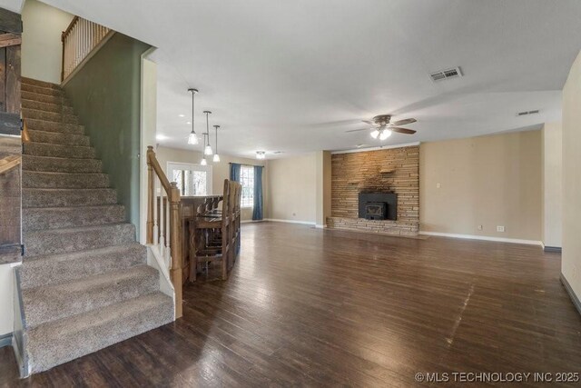 9012 S 49th W Ave, Tulsa, OK 74131 - unfurnished living room featuring dark wood-style floors, stairway, visible vents, and ceiling fan