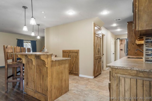 9012 S 49th W Ave, Tulsa, OK 74131 - bar with visible vents, baseboards, a barn door, a sink, and freestanding refrigerator