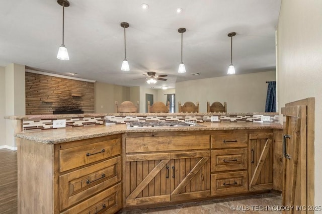 9012 S 49th W Ave, Tulsa, OK 74131 - kitchen featuring brown cabinets, backsplash, open floor plan, and light stone counters