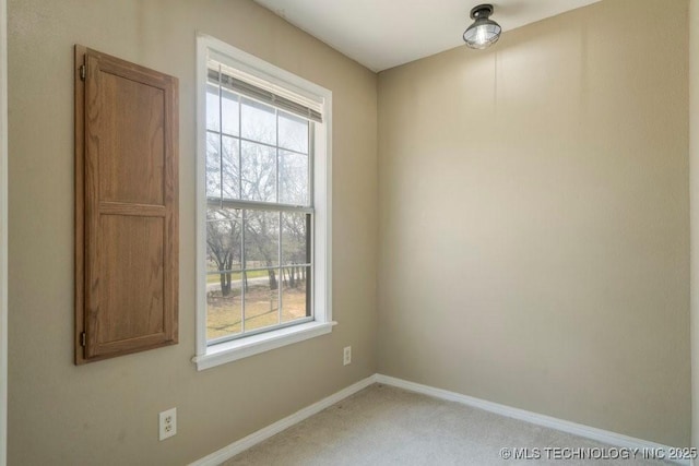 9012 S 49th W Ave, Tulsa, OK 74131 - unfurnished room featuring a wealth of natural light, baseboards, and carpet floors
