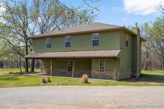 9012 S 49th W Ave, Tulsa, OK 74131 - country-style home featuring a front yard, a chimney, stone siding, and roof with shingles