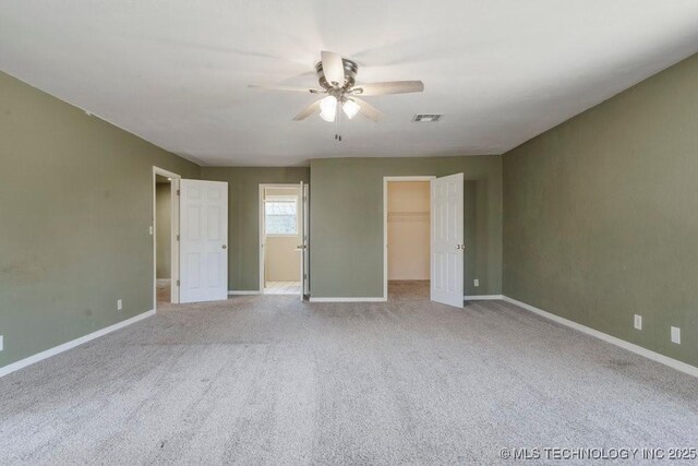 9012 S 49th W Ave, Tulsa, OK 74131 - unfurnished bedroom featuring visible vents, baseboards, a walk in closet, and carpet flooring