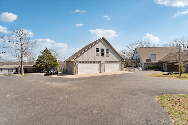 20136 W Chicken Creek Rd, Cookson, OK 74427 - view of front of property featuring stone siding, driveway, and a garage