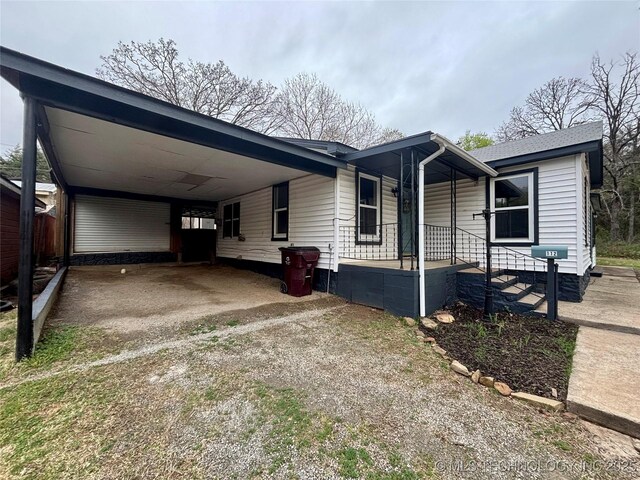 112 S 7th St, Eufaula, OK 74432 - view of front of property featuring a carport, dirt driveway, and covered porch