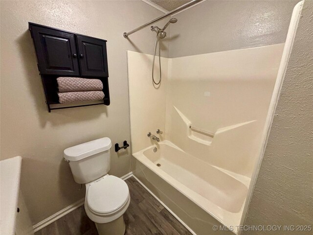 112 S 7th St, Eufaula, OK 74432 - bathroom featuring wood finished floors, washtub / shower combination, toilet, and baseboards