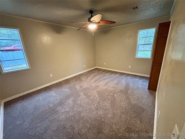 112 S 7th St, Eufaula, OK 74432 - spare room with ornamental molding, a ceiling fan, dark colored carpet, baseboards, and a textured ceiling