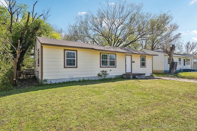 ranch-style home with a front yard