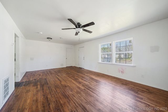 spare room with visible vents, baseboards, a ceiling fan, and wood finished floors