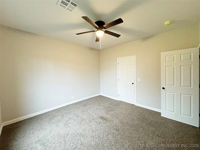 unfurnished bedroom with baseboards, ceiling fan, visible vents, and dark colored carpet