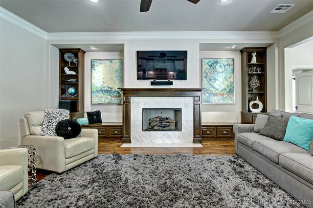 7415 E 109th St S, Tulsa, OK 74133 - living room with wood finished floors, a premium fireplace, visible vents, ceiling fan, and ornamental molding
