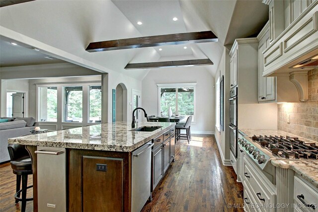 7415 E 109th St S, Tulsa, OK 74133 - kitchen featuring vaulted ceiling with beams, decorative backsplash, a sink, appliances with stainless steel finishes, and ventilation hood