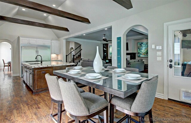 7415 E 109th St S, Tulsa, OK 74133 - dining room with vaulted ceiling with beams, arched walkways, ceiling fan, and stairs