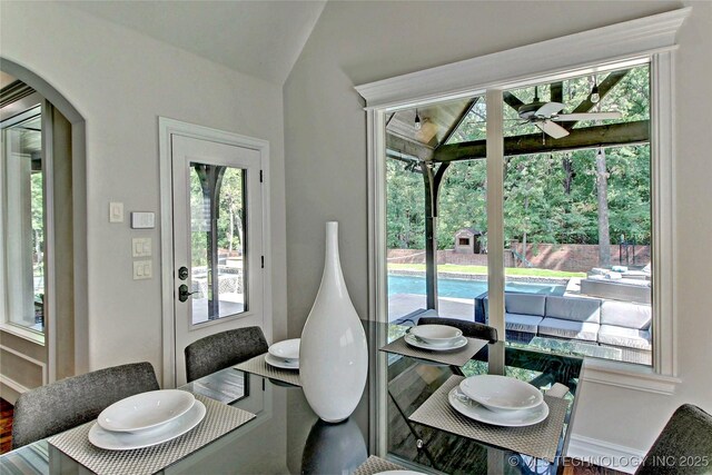 7415 E 109th St S, Tulsa, OK 74133 - dining space featuring a ceiling fan, arched walkways, and vaulted ceiling