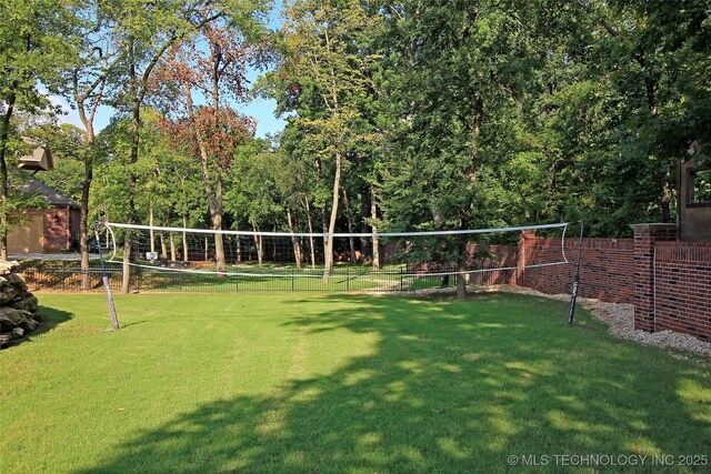 7415 E 109th St S, Tulsa, OK 74133 - view of home's community with a lawn, fence, and volleyball court