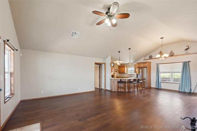 unfurnished living room featuring dark wood-style flooring, visible vents, and vaulted ceiling