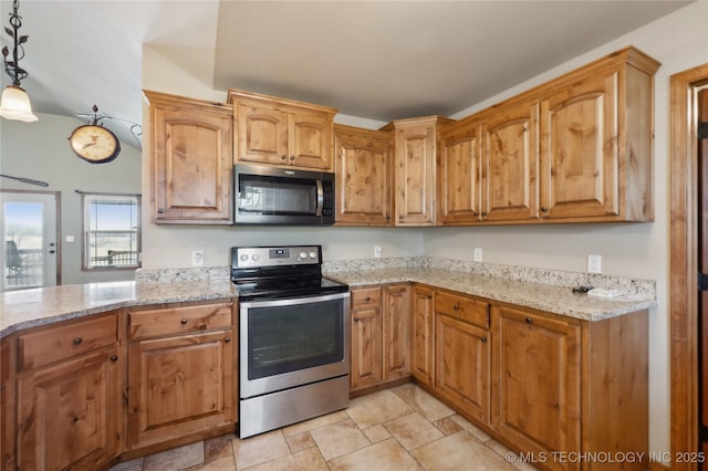 kitchen with light stone counters, brown cabinetry, appliances with stainless steel finishes, and pendant lighting
