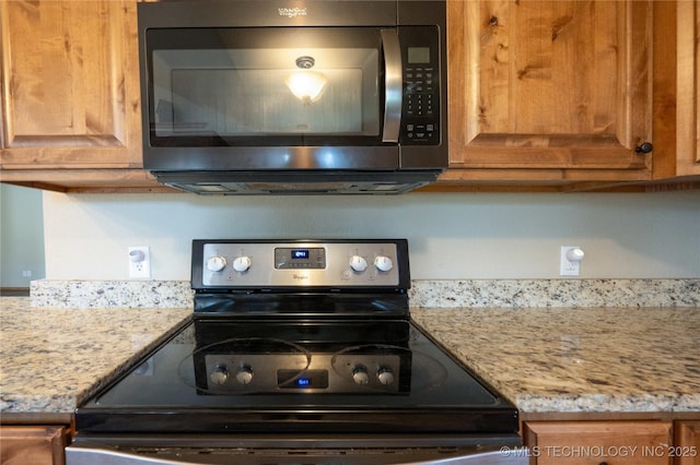 kitchen featuring light stone countertops, stainless steel electric stove, and brown cabinetry