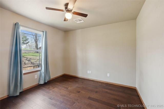 unfurnished room with baseboards, visible vents, a ceiling fan, and hardwood / wood-style floors