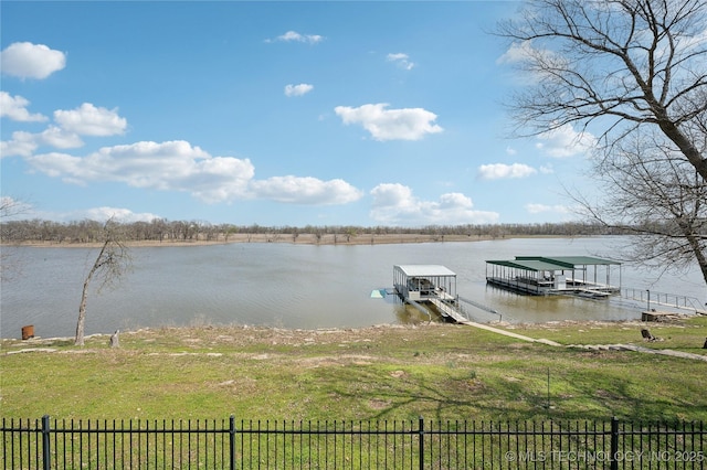 dock area with a water view, fence, and boat lift