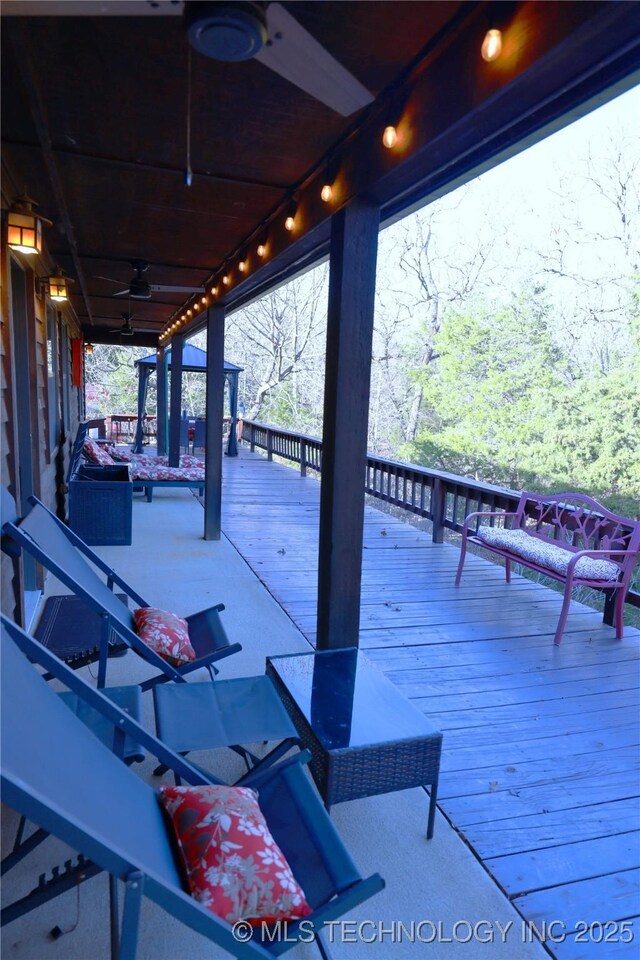 view of patio with a wooden deck and ceiling fan