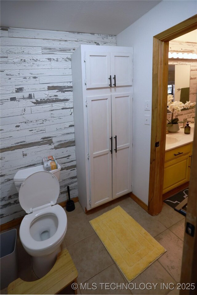 bathroom featuring baseboards, toilet, tile patterned flooring, and vanity