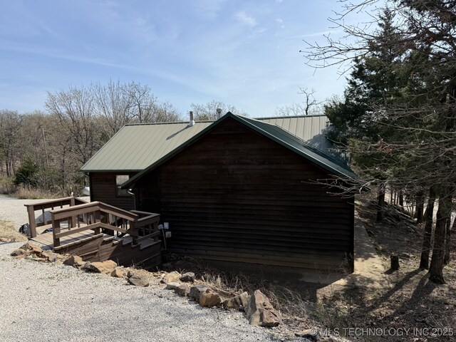 view of side of property featuring metal roof
