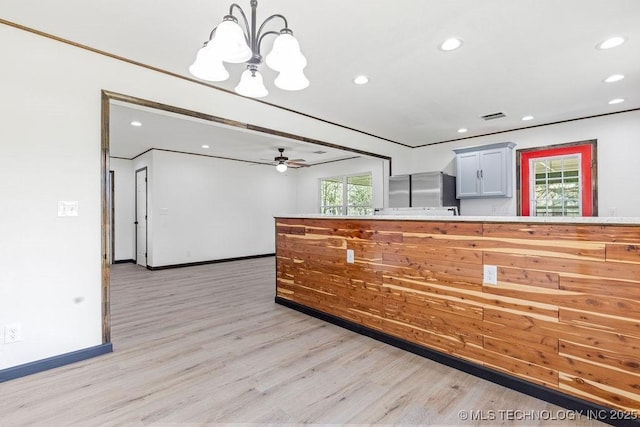 kitchen featuring a wealth of natural light, light wood-style floors, a chandelier, and visible vents