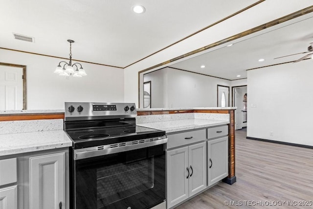 kitchen with a chandelier, light wood finished floors, stainless steel range with electric stovetop, visible vents, and decorative light fixtures