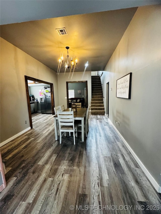 dining room with visible vents, stairs, baseboards, dark wood finished floors, and a notable chandelier