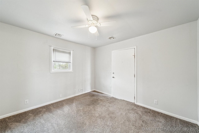 unfurnished room with carpet flooring, a ceiling fan, and visible vents